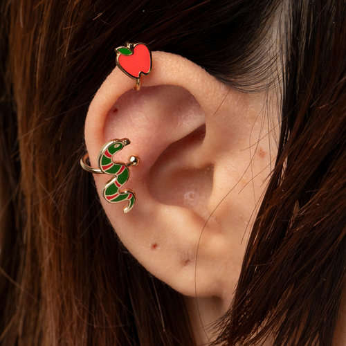 Gold apple and snake no-piercing ear cuffs worn on ear by Yellow Owl Workshop
