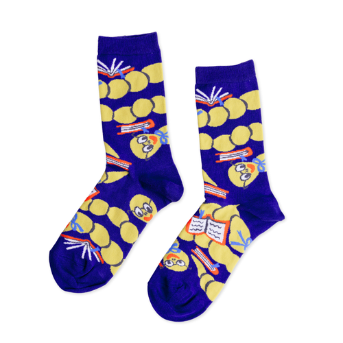 Navy blue crew socks featuring illustrated bookworms wearing glasses and reading open books on yellow polka dot background by Yellow Owl Workshop
