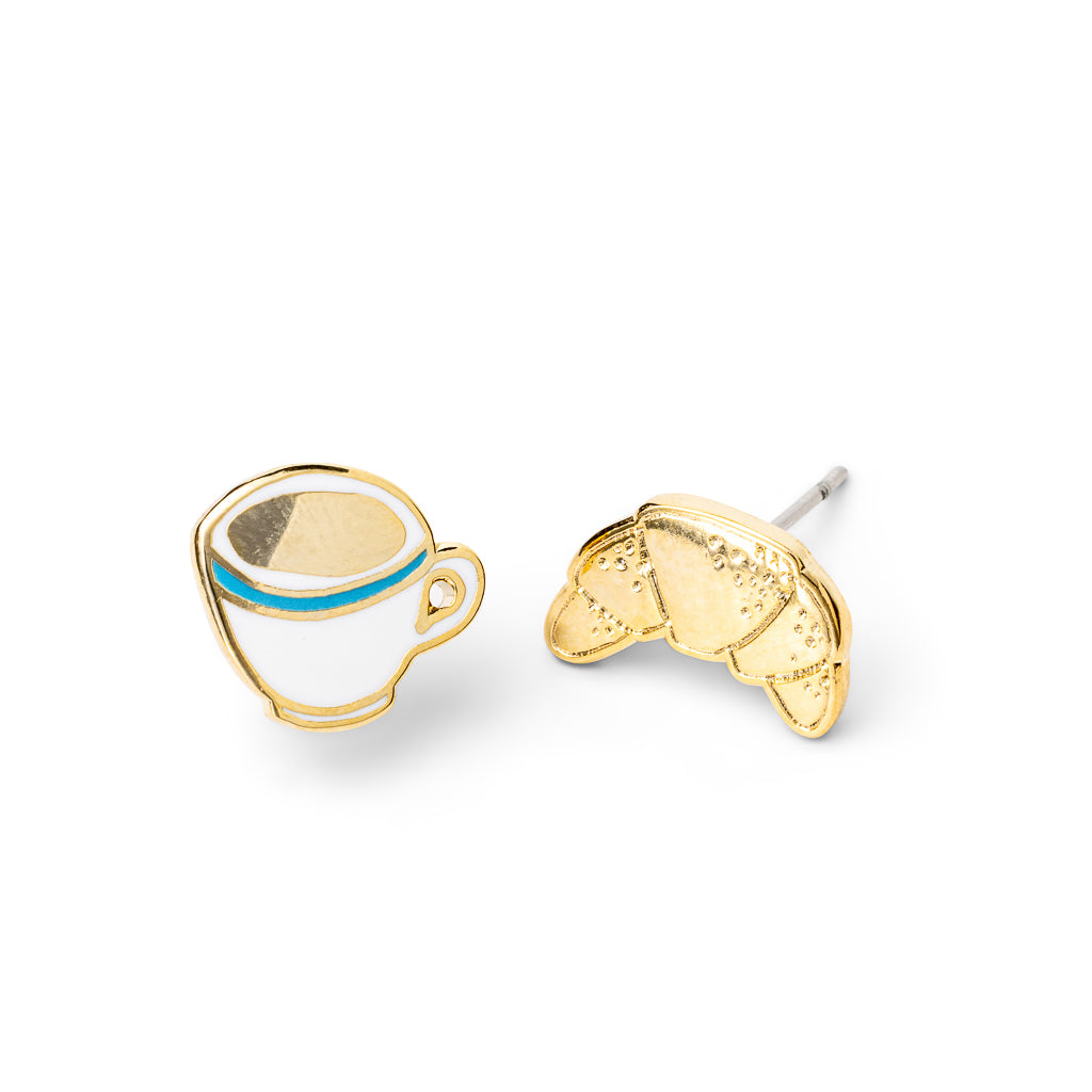 Mismatched cloisonné stud earrings featuring white coffee cup with blue stripe and gold croissant gilded in 22 karat gold by Yellow Owl Workshop