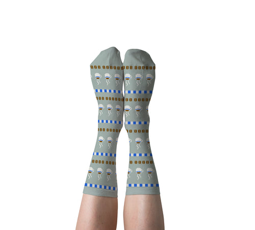 Sage green Coffee crew socks with steaming mugs and coffee beans worn on feet by Yellow Owl Workshop