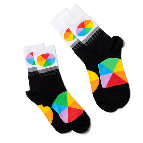 Color Wheel crew socks small and large sizes laid out side by side by Yellow Owl Workshop