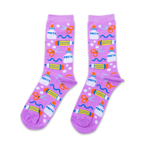 Purple crew socks featuring illustrated craft supplies including scissors paste bottles and pencils by Yellow Owl Workshop