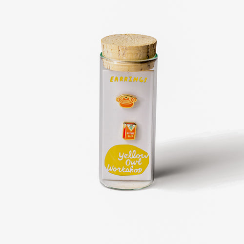 Dutch oven and kosher salt mismatched cloisonné stud earrings in glass vial packaging by Yellow Owl Workshop