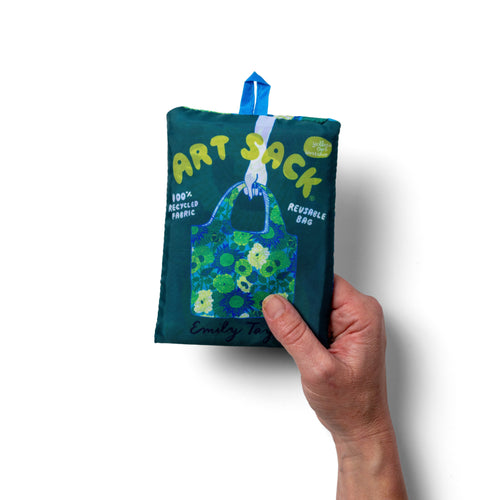 Person holding illustrated floral tote bag with bold oversized cobalt and chartreuse bloom print by Emily Taylor for Yellow Owl Workshop