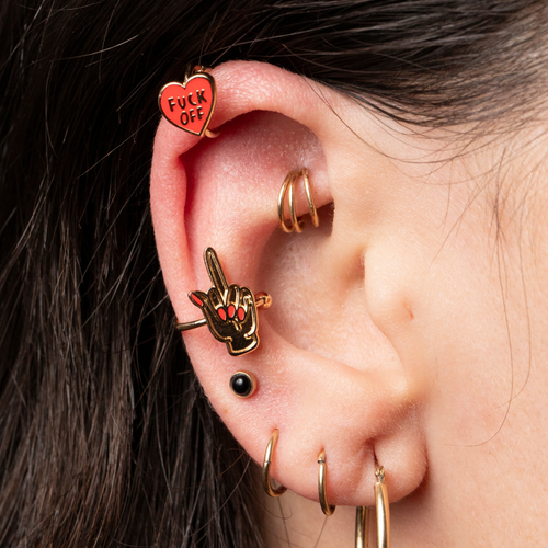 Gold Fuck Off and Middle Finger no-piercing ear cuffs worn on ear by Yellow Owl Workshop