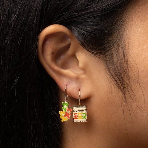 Gummies mismatched enamel drop earrings worn on ear by Yellow Owl Workshop