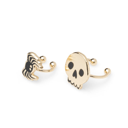 Yellow Owl Workshop mismatched skull and spider ear cuffs featuring a gold-tone skull with black eyes and a black spider with gold details. Adjustable, no-piercing ear cuff jewelry for Halloween, spooky season, and gothic-inspired outfits, photographed on a white background.