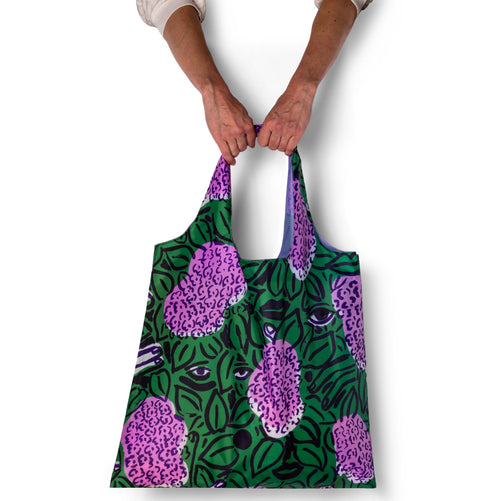Person holding illustrated botanical tote bag with painted lilac print by Sophy Naess for Yellow Owl Workshop