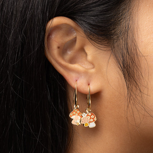 Mushroom Butterfly mismatched enamel drop earrings worn on ear by Yellow Owl Workshop