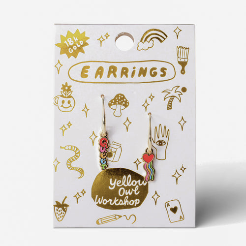 Queer Heart mismatched enamel drop earrings on gold foil matchbook card by Yellow Owl Workshop