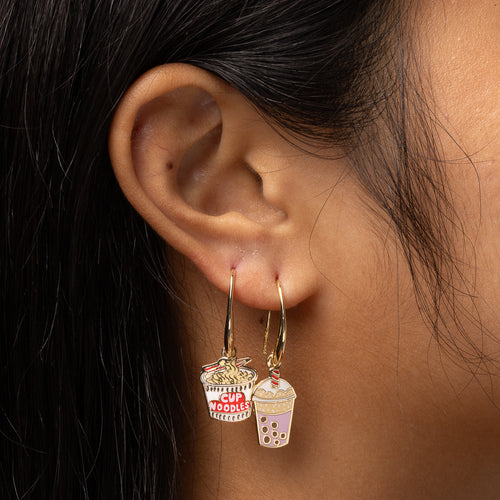 Ramen and Boba mismatched enamel drop earrings worn on ear by Yellow Owl Workshop