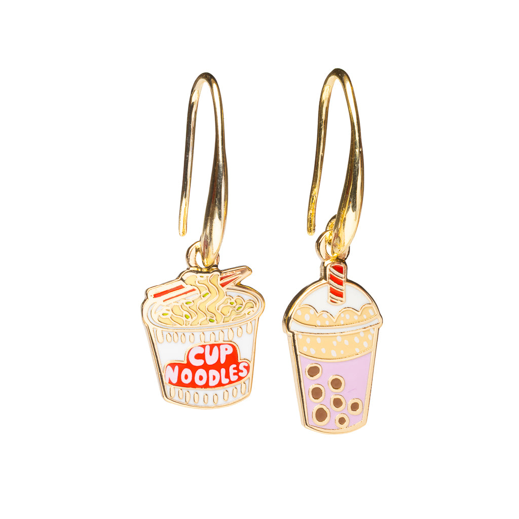 Mismatched enamel drop earrings featuring cup noodles and lavender boba drink with tapioca pearls by Yellow Owl Workshop