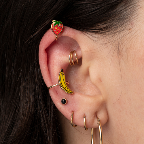 Gold strawberry and banana no-piercing ear cuffs worn on ear by Yellow Owl Workshop