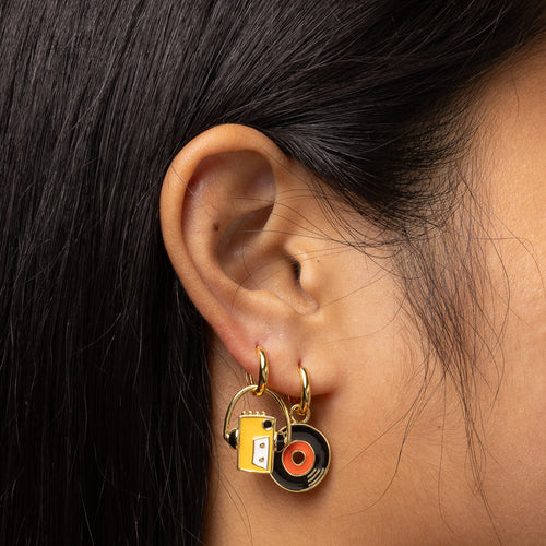 Walkman and vinyl record gold hoop earrings worn on ear by Yellow Owl Workshop