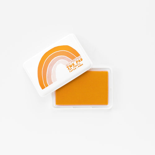 Orange permanent waterproof all-purpose ink pad open showing orange ink pad and white rainbow lid by Yellow Owl Workshop