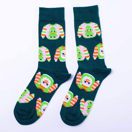 Teal crew socks featuring illustrated ugly Christmas sweaters with Christmas trees and orange green stripes by Yellow Owl Workshop
